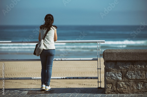 lonely person looking at the sea