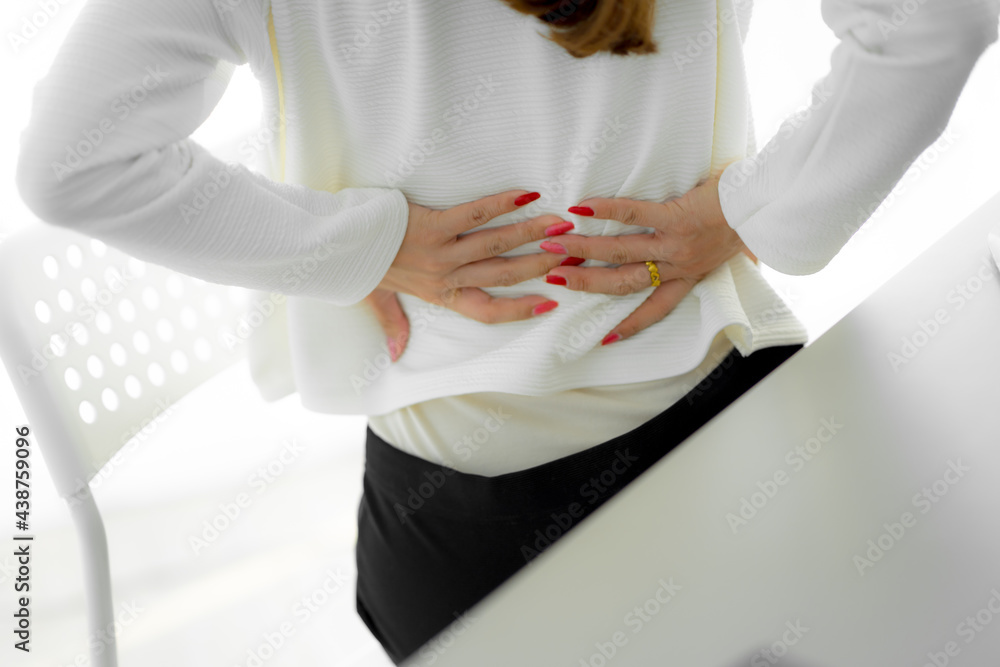 Asian woman with back pain in office