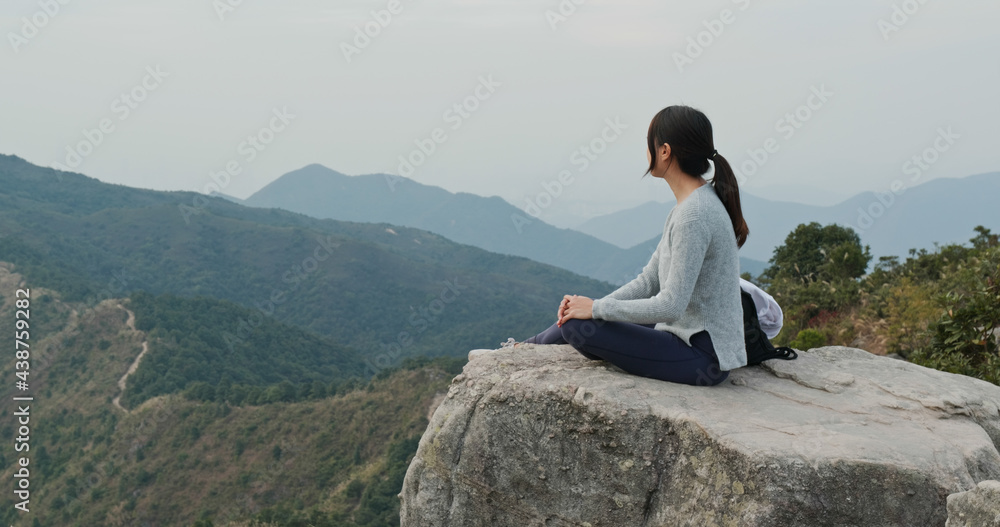 Woman sit on the top of mountain