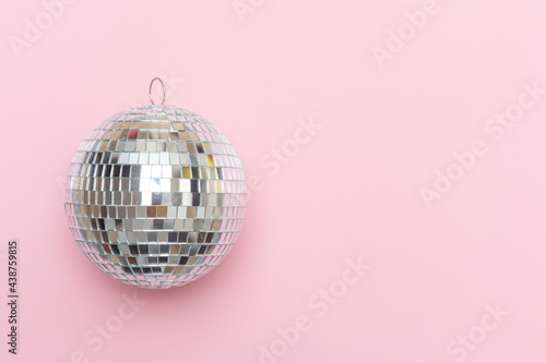 Disco ball on pink background isolated.