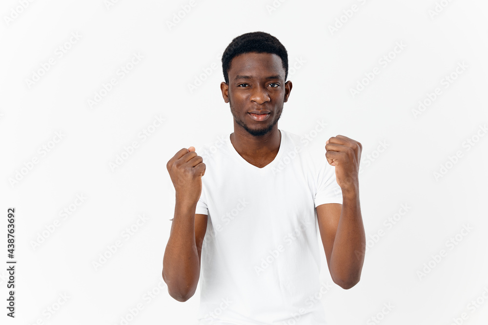 man of african appearance in white t-shirt gestures with hands emotions modern style man of african appearance in white t-shirt gestures with hands emotions modern style