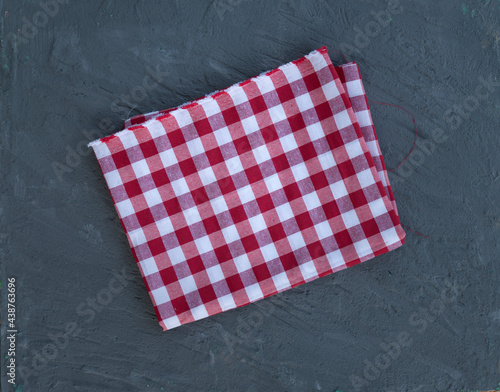 Empty wooden deck with table cloth, napkin over wall background