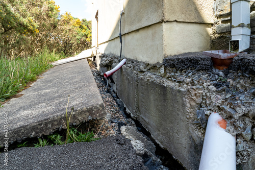 Broken pipes due to subsidence of building on a peatbog photo