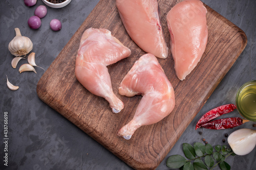 Raw fresh  chicken drumsticks and breast photo