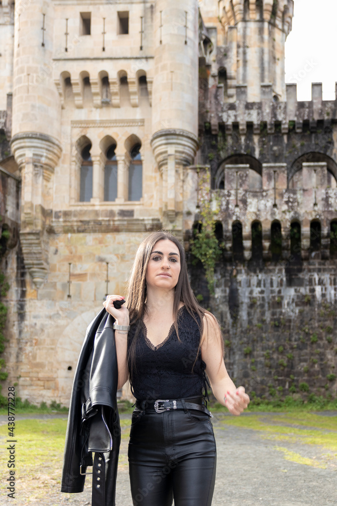 young brunette woman dressed in leather clothes walking young brunette woman dressed in leather clothes walking