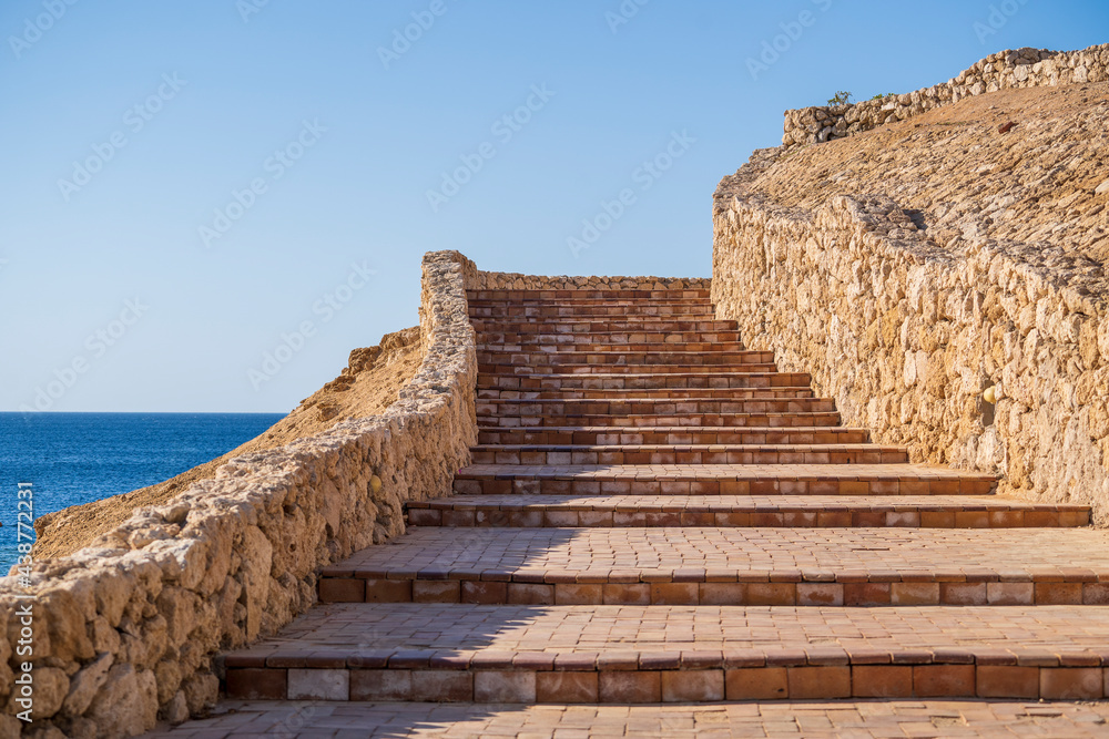 Detail of stairs and stone wall on the beach near sea water of Egypt in Sharm El Sheikh Detail of stairs and stone wall on the beach near sea water of Egypt in Sharm El Sheikh