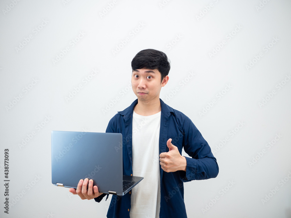 Handsome man asian holding laptop show thumb up confident face on white wall background Handsome man asian holding laptop show thumb up confident face on white wall background