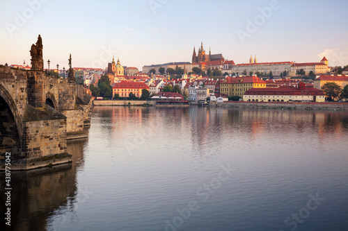 Prague at sunrise. Cityscape image of Prague, capital city of Czech Republic with St. Vitus Cathedral and Charles Bridge at sunrise.