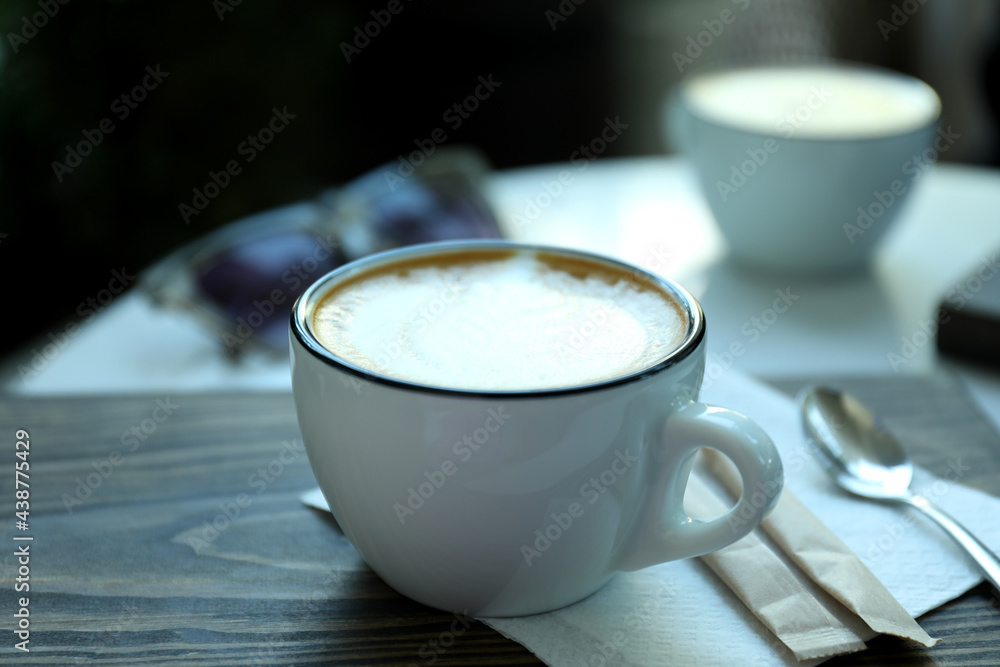 Cup of delicious coffee on wooden table outdoor in restaurant Cup of delicious coffee on wooden table outdoor in restaurant