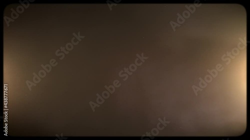Authentic Super 8 Sharp Film Frame with Both Sides Light Rays for Retro Vintage Effect. Sepia Coloured Noise, grain, scratches seamless looped texture. VFX Overlay Footage.