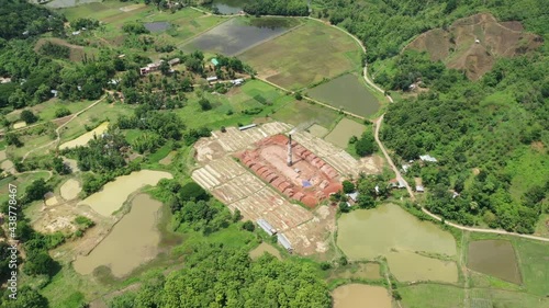 Aerial view of several chimneys from a brick factory along Buriganga river near Keraniganj township, Dhaka province, Bangladesh. photo