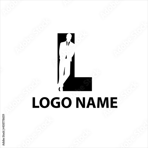 presentable man in a suit is leaning against the letter L negative space