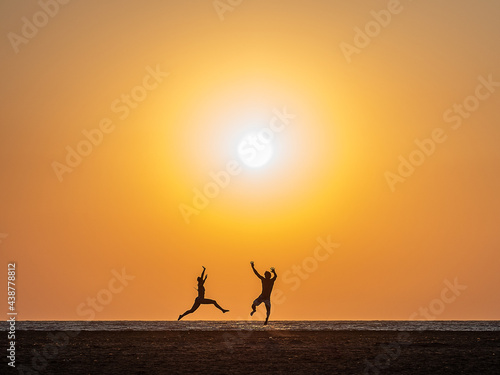 silhouette of a person jumping on the beach
