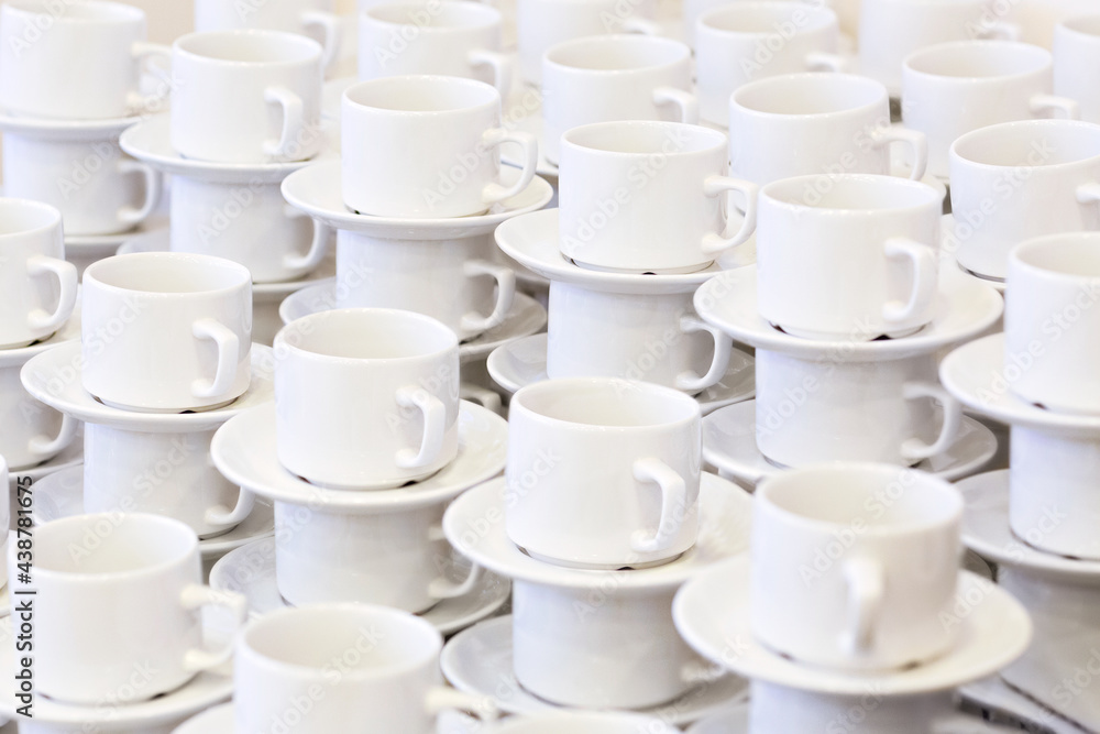 Abstract background, a pattern of many white cups. Dishes at the hotel. Abstract background, a pattern of many white cups. Dishes at the hotel.