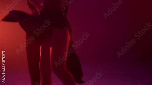 Dancers body moving in dark background. Unknown couple dancing rumba indoors.