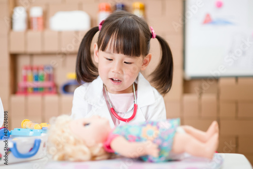 young girl pretend play doctor role at home