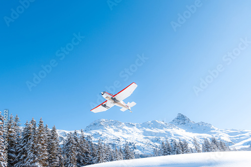Propeller airplane in mountain winter landscape