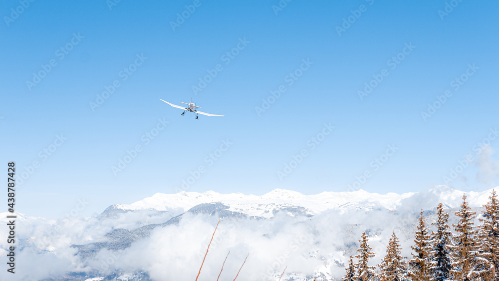 Propeller airplane in mountainous winter landscape Propeller airplane in mountainous winter landscape