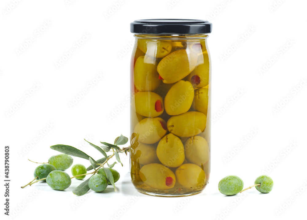 Glass jar with pickled olives, and olive branch near Isolated on white background Glass jar with pickled olives, and olive branch near Isolated on white background