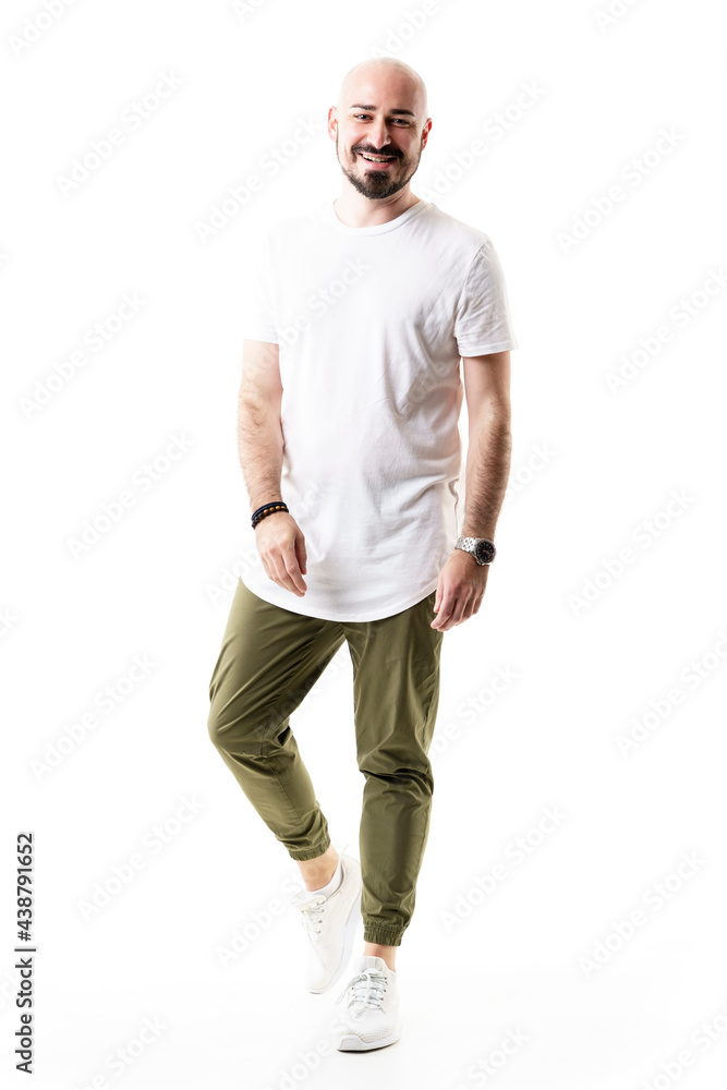 Happy young shaved bald bearded man in blank white shirt smiling. Full body length isolated on white background Happy young shaved bald bearded man in blank white shirt smiling. Full body length isolated on white background