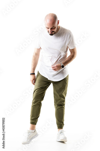 Casual bald stylish man looking down searching something on ground. Full body length isolated on white background © sharplaninac