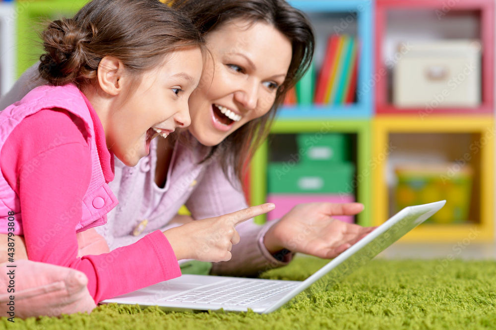 happy mother and daughter using laptop together happy mother and daughter using laptop together