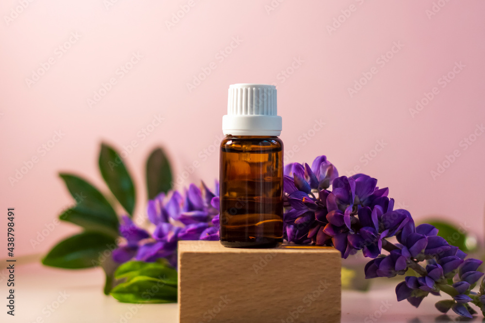 Bottle without label with oil on the stand. Transparent glass container with a dispenser on a beige-pink background. Product banner. Space for text, design. Bottle without label with oil on the stand. Transparent glass container with a dispenser on a beige-pink background. Product banner. Space for text, design.