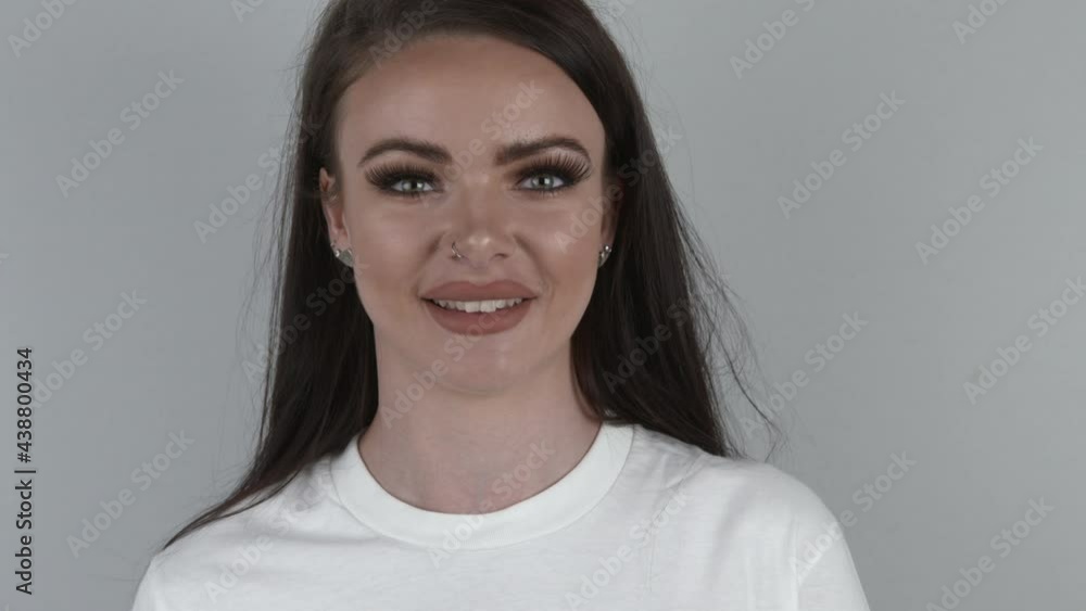 Attractive model facing straight ahead at the camera and blowing a kiss. Woman in love on a white background. Girl sending her love concept. Attractive model facing straight ahead at the camera and blowing a kiss. Woman in love on a white background. Girl sending her love concept.