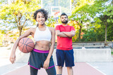 Woman and man portrait, playing basketball in Toronto