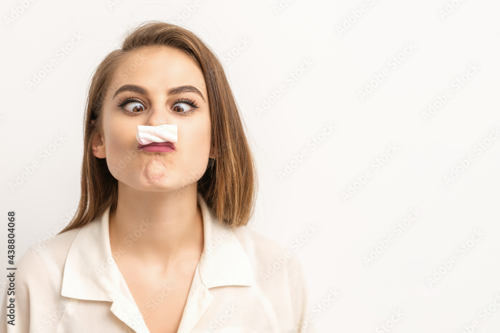 Young funny woman with sweet candy marshmallow-like mustache over white background. Depilation and epilation concept Young funny woman with sweet candy marshmallow-like mustache over white background. Depilation and epilation concept