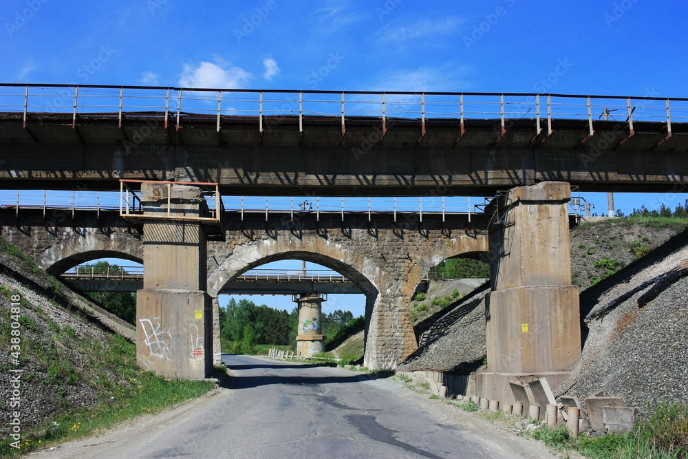 Old abandoned railway viaduct over the road