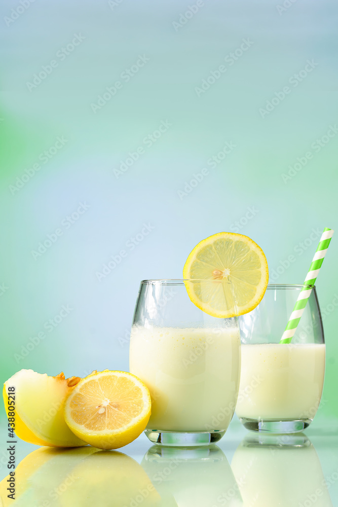 glasses with melon juice with milk and Sicilian lemon on reflective surface glasses with melon juice with milk and Sicilian lemon on reflective surface
