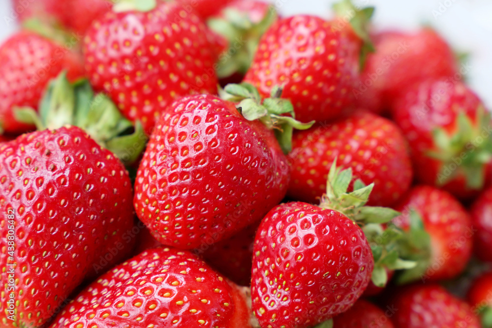 Fresh red strawberries with leaves. Pile of ripe strawberry for background Fresh red strawberries with leaves. Pile of ripe strawberry for background