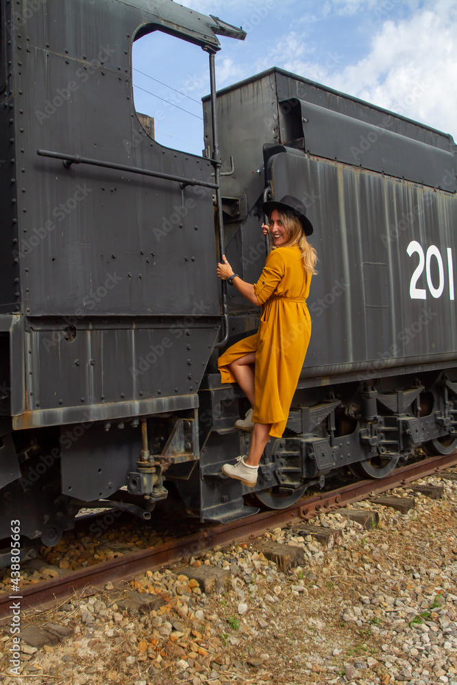 young woman with a yellow dress traveling in a train around Spain 