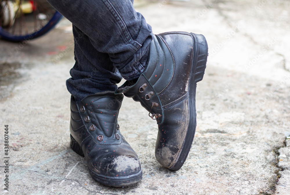 Wear safety shoes to ensure safety at work. construction workers wear safety shoes Stock Photo