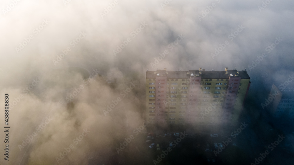 Fototapeta premium Top view of the city in fog and smog. Pictures from the drone.