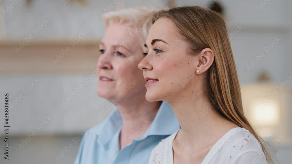 Headshot close-up profile faces happy dreamy beautiful 2 two age generations women. Affectionate mature 60s middle-aged mom and young adult daughter. Parents and offspring, genes, family concept Headshot close-up profile faces happy dreamy beautiful 2 two age generations women. Affectionate mature 60s middle-aged mom and young adult daughter. Parents and offspring, genes, family concept