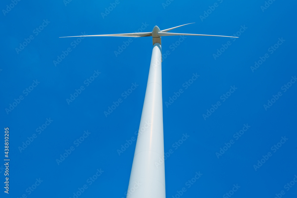 Wind turbine under construction in an agricultural field with vegetables below a blue sky in springtime, Almere, Flevoland, Netherlands, June 10, 2021 Wind turbine under construction in an agricultural field with vegetables below a blue sky in springtime, Almere, Flevoland, Netherlands, June 10, 2021