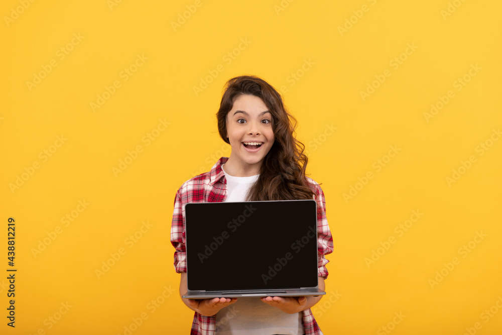 Naklejka premium amazed smart child presenting laptop at school online lesson, school presentation