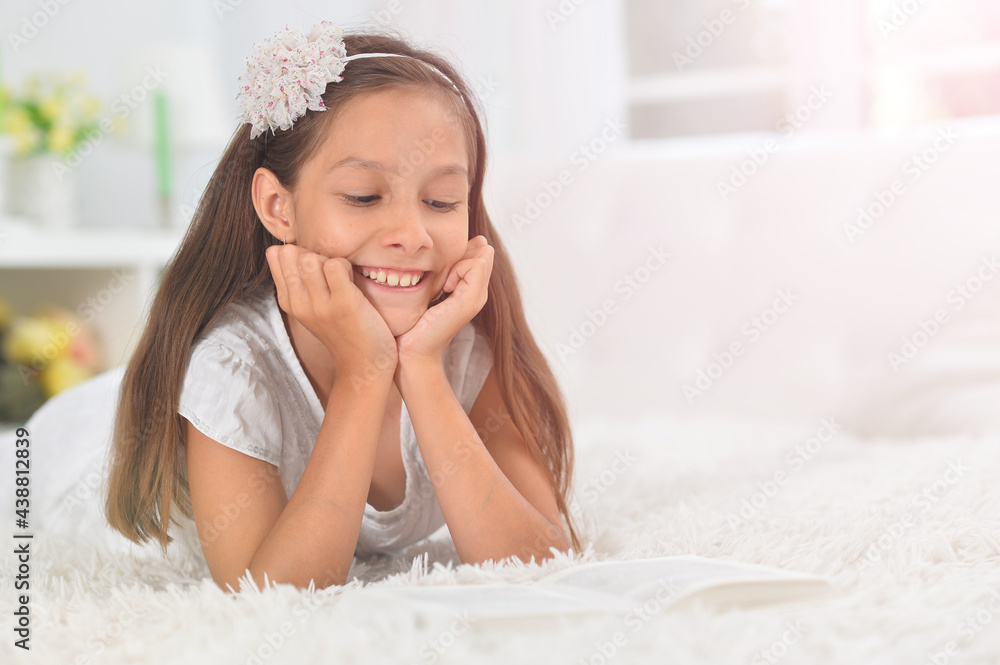 little cute girl reading book at home little cute girl reading book at home