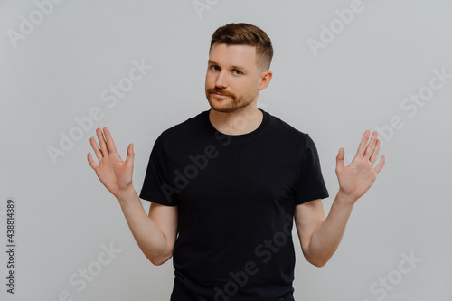 Young handsome male in casual t shirt saying no or rejecting proposition