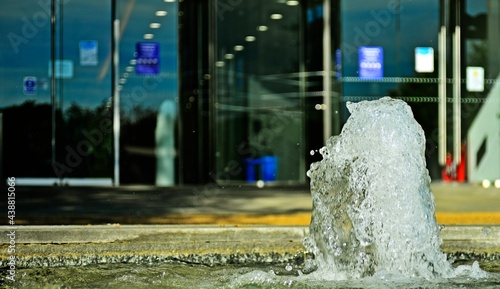 Water fountain close up with building entrance at the background