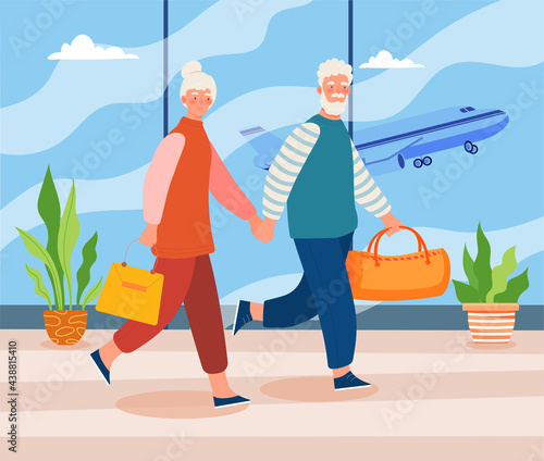 Elderly couple in airport terminal holding hands