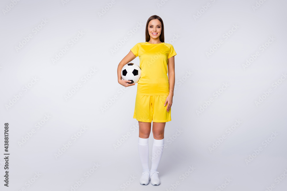 Full body photo of sporty shapes captain lady player soccer women team hold leather ball wear yellow football uniform t-shirt shorts boots knee socks isolated white color background Full body photo of sporty shapes captain lady player soccer women team hold leather ball wear yellow football uniform t-shirt shorts boots knee socks isolated white color background