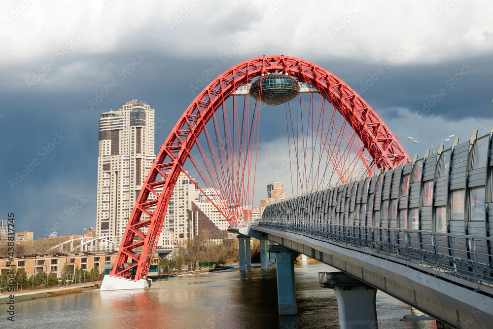 Obraz premium Beautiful cable-stayed Zhivopisny bridge in Moscow, Russia. It is the highest suspension bridge in Europe and landmark of Moscow. Nice panorama of modern buildings in Moscow.