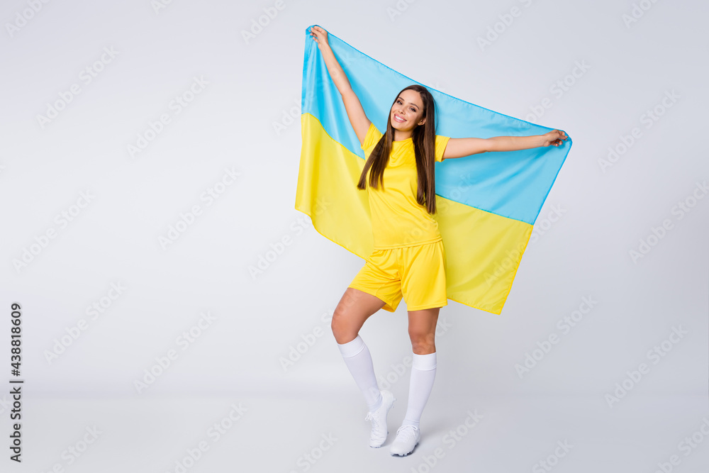 Full length body size view of her she nice beautiful glad cheerful straight-haired girl fan holding in hands Ukrainian flag celebrating holiday isolated over light white gray pastel color background Full length body size view of her she nice beautiful glad cheerful straight-haired girl fan holding in hands Ukrainian flag celebrating holiday isolated over light white gray pastel color background