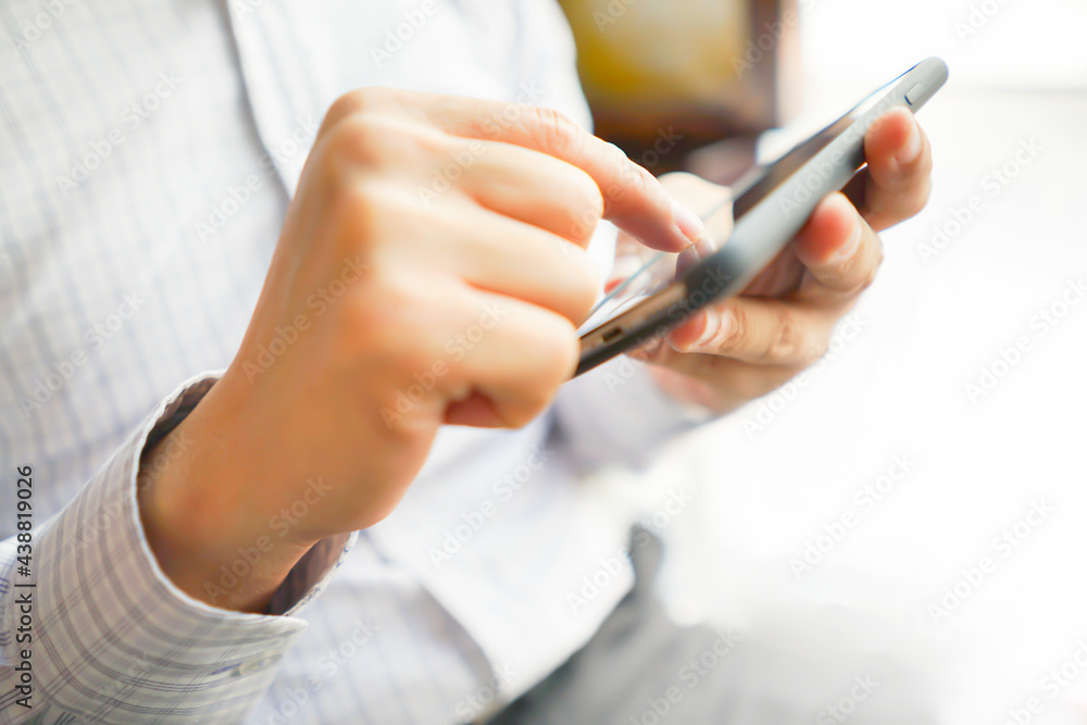 Smartphone Mobile phone hold touch in a Asian people hand in coffee shop restaurant waiting for friends with hand touching a Smart Phone, Technology smartphone communication Background Concept Smartphone Mobile phone hold touch in a Asian people hand in coffee shop restaurant waiting for friends with hand touching a Smart Phone, Technology smartphone communication Background Concept