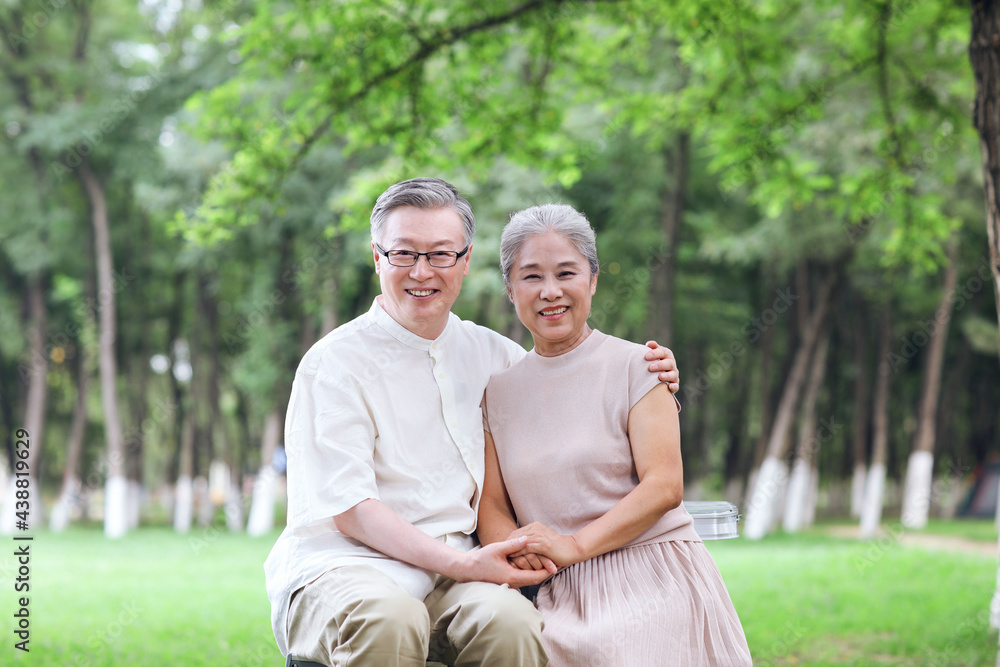 Happy old couple sitting on chairs in outdoor park Happy old couple sitting on chairs in outdoor park
