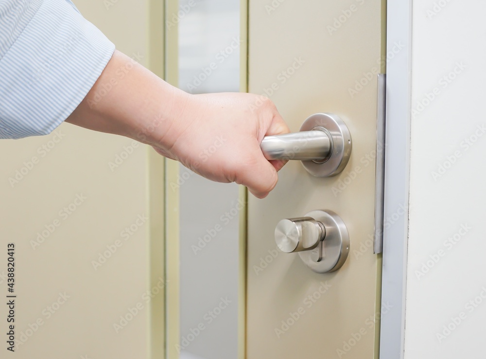 A hand to opening/close door knob, Home Security and Safety Background Concept A hand to opening/close door knob, Home Security and Safety Background Concept