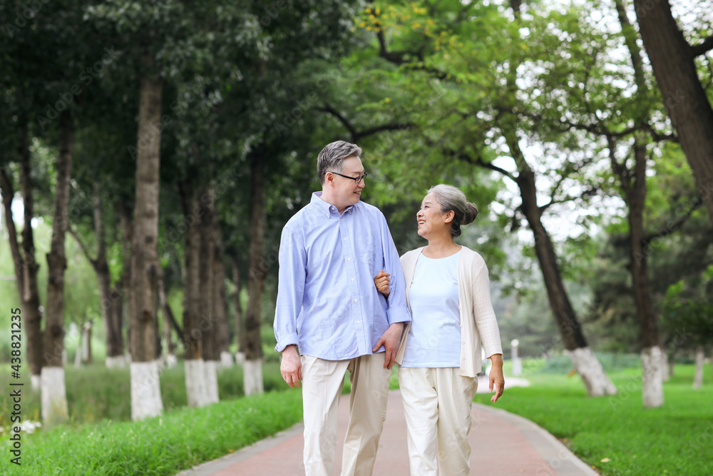 Happy old couple walking in the park Happy old couple walking in the park